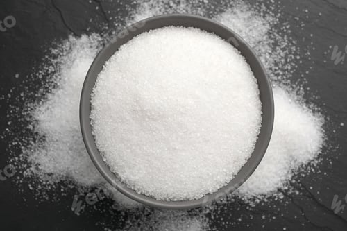 Preview: Granulated sugar on black table, top view