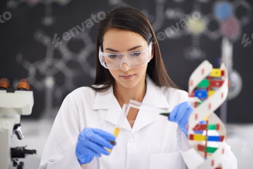 Preview: Advancement in genetics improving life. Shot of a female scientist pouring liquid into a test tube.