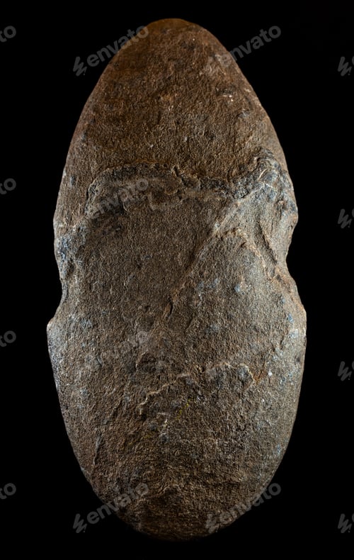 Preview: Vertical shot of a stone with notches for use as an ancient fishing weight in Prehistory