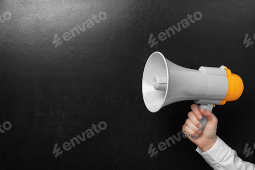 Preview: Man holding megaphone near chalkboard