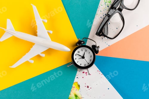 Preview: Time to travel concept. plastic plane jet toy passenger with alarm clock
