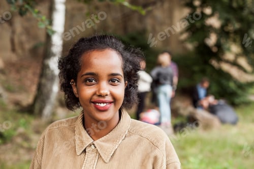 Preview: Portrait of happy young woman smiling outdoors