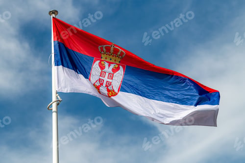Preview: The national flag of Serbia waving in the blue sky