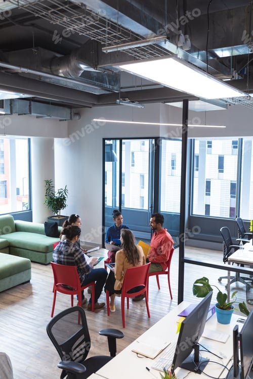 Preview: Diverse group of creative colleagues talking at casual meeting