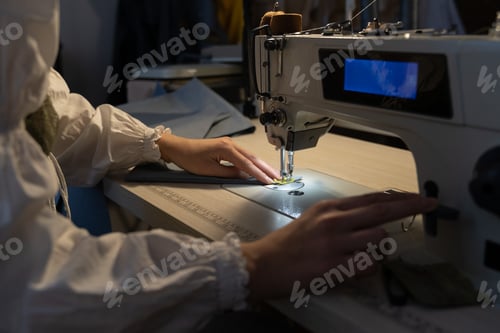Preview: Seamstress work on sewing machine, closeup. Woman fashion designer create new clothes collection