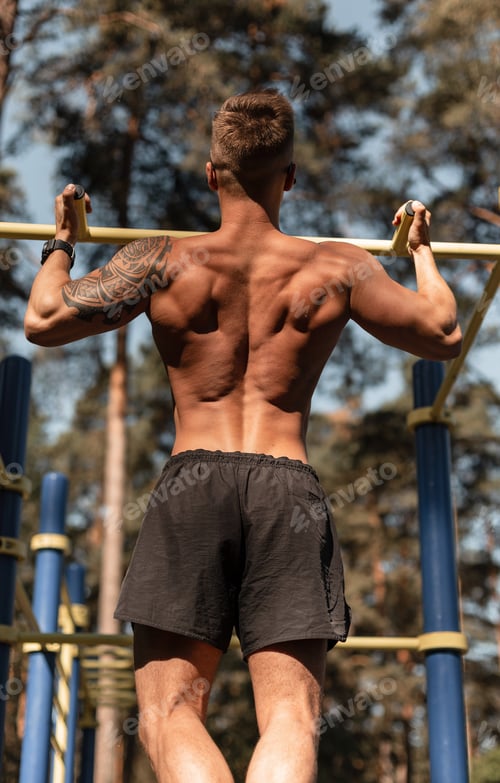 Preview: Cool handsome healthy muscular athletic man training outdoors