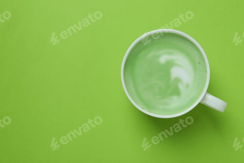 Preview: Cup of matcha latte on green background