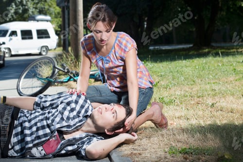 Preview: Woman helping injured man lying on roadside