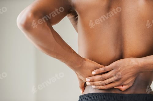 Preview: Pain in back. Cropped image of young African man touching his back