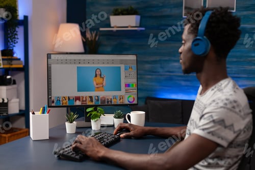Preview: Photographer designer artist sitting at desk retouching photo