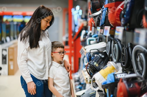 Preview: Mother and son shopping for electric vacuum cleaner, smiling