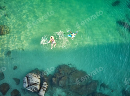 Preview: Aerial view Happy smiling children with bodyboard.
