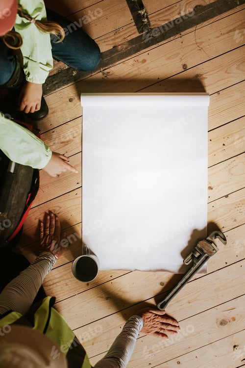 Preview: Child and Adult Looking at Blueprints on Floor