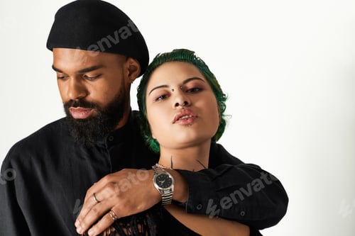 Preview: Stylish multicultural couple showcasing fashion with confidence in a studio setting