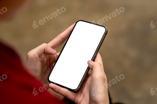 Preview: Close-up of businesswoman holding a smartphone blank white screen and relax at the office. Mock up.