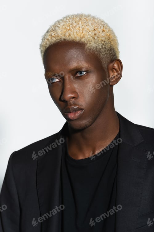 Preview: portrait of blonde african american man in black blazer isolated on grey