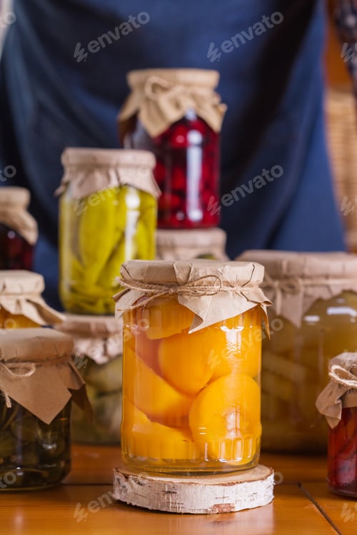 Preview: Young man holding in hands preserved food