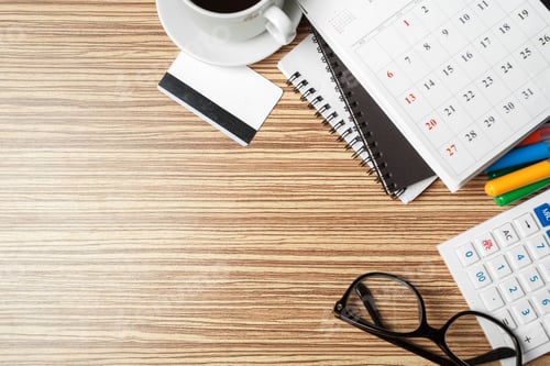 Preview: Desk setup with coffee, calendar, notebook, and office supplies for planning activities