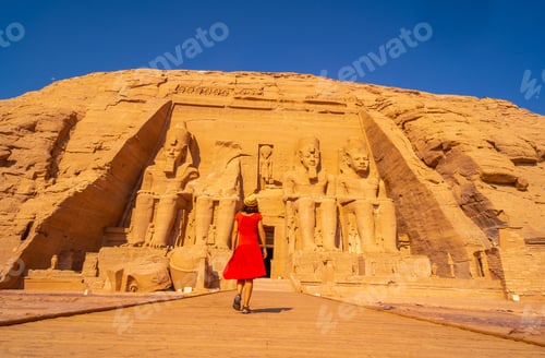 Preview: A European Tourist In Red Dress Walking Towards The Abu Simbel Temple In Southern Egypt In Nubia