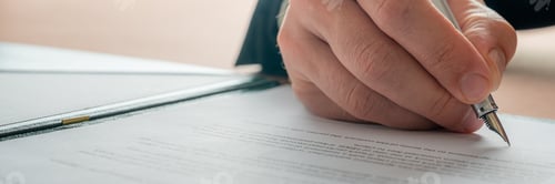 Preview: Businessman signing a document contract with ink pen
