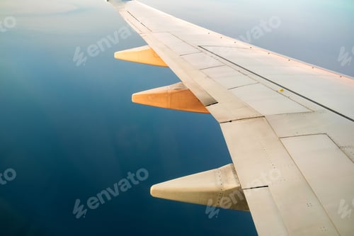 Preview: View from airplane on the aircraft white wing flying over ocean landscape in sunny morning. Air