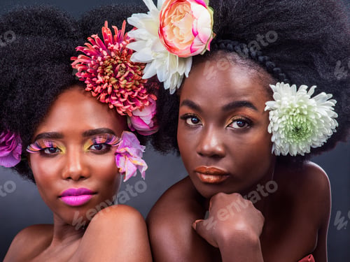 Preview: Cropped shot of two beautiful women posing together with flowers in their hair