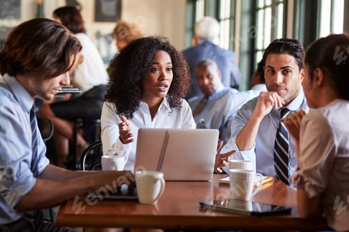 Preview: Business Team Having Informal Meeting Around Table In Coffee Shop