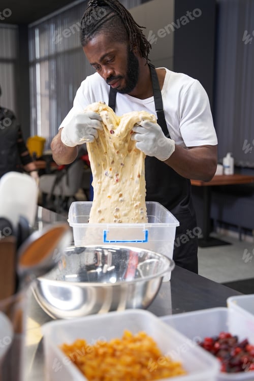 Preview: African man cooking dessert at the kitchen