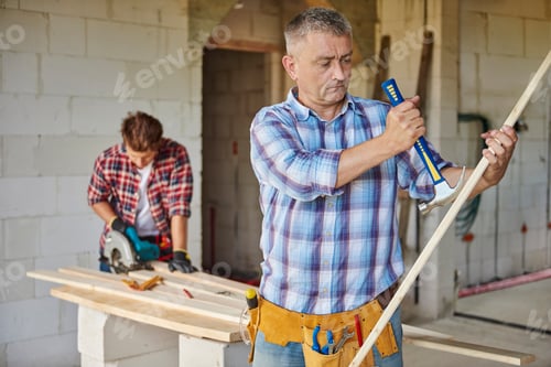 Preview: Motivated carpenter and hammer in the main plan