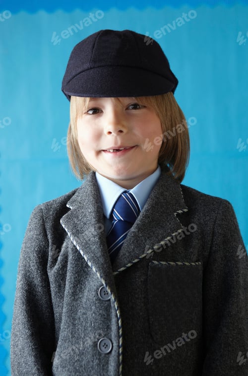 Preview: Boy in school uniform smiling at camera with a toothy grin