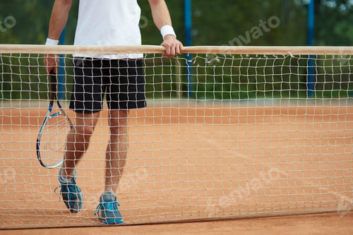 Preview: Man standing behind a tennis net
