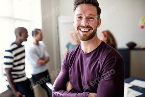 Preview: Laughing young designer standing in an office after a meeting