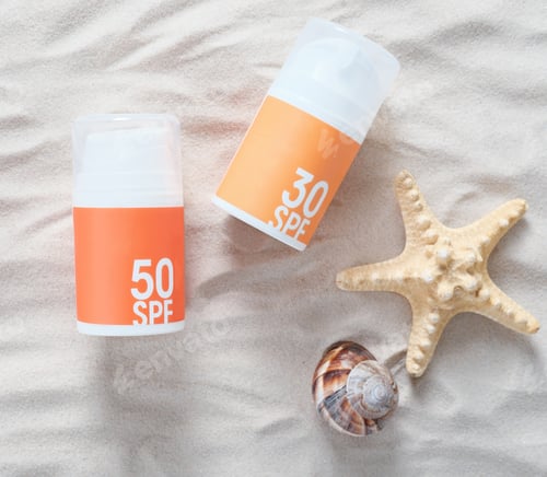 Preview: sun tan protection creme bottles on a sand next to starfish and seashell. summer skin care concept.