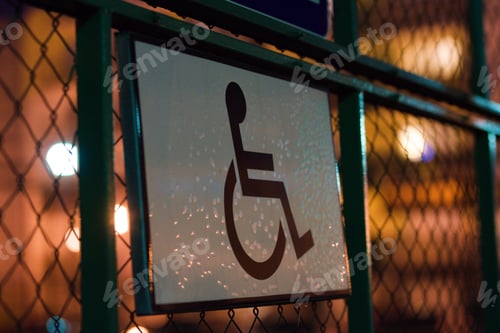 Preview: Sign of a person in a wheelchair for people with disabilities on the fence