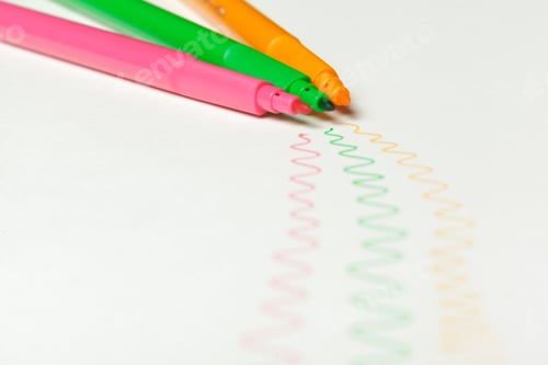 Preview: Three felt-tip pens of pink, orange and green color with drawn color marks on white background