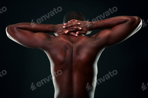 Preview: Back view portrait of a african man over black background