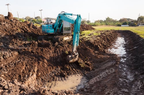 Preview: excavator backhoe working in the digging a soil to adjust the post harvest areas in the rice fields.