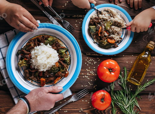 Preview: Turkish cuisine family feast. Flat-lay of people celebrating with lamb chops, quince, bean