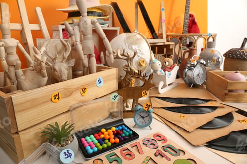 Preview: Many different items on white table indoors. Garage sale