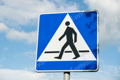 Preview: Vertical signage of crosswalk over cloudy sky, road sign pedestrian crossing. Attention road sign