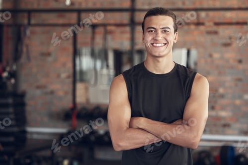 Preview: Portrait of a proud young man standing in the gym. Happy young man arms crossed in the gym. Smiling