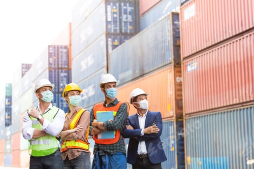 Preview: Group of logistic worker in arms crossed at container warehouse