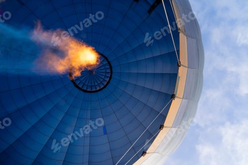 Preview: View from below of a hot air balloon heating the air with the flame seen from inside