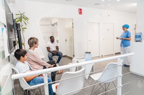Preview: Dental hygienist calling patients from the waiting room in a modern dental clinic