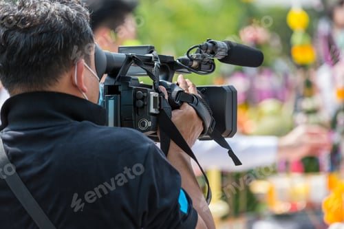 Preview: Video camera operator working with his equipment. video cinema production.