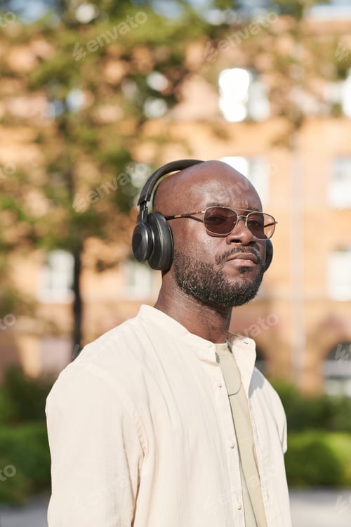 Preview: Portrait of black man in wireless headphones
