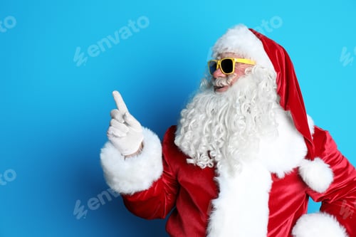 Preview: Authentic Santa Claus wearing sunglasses on color background