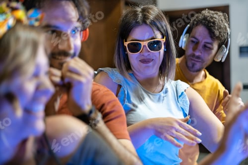 Preview: Group of young people improvising party and dancing at home while having fun together