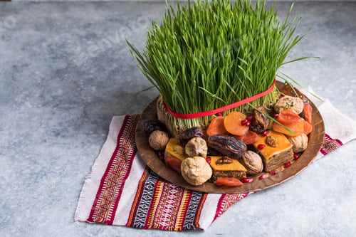 Preview: Novruz plate with Azerbaijan national pastry pakhlava and shekerbura and green semeni wheat grass
