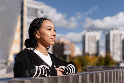 Preview: Woman looking away thinking about future in city